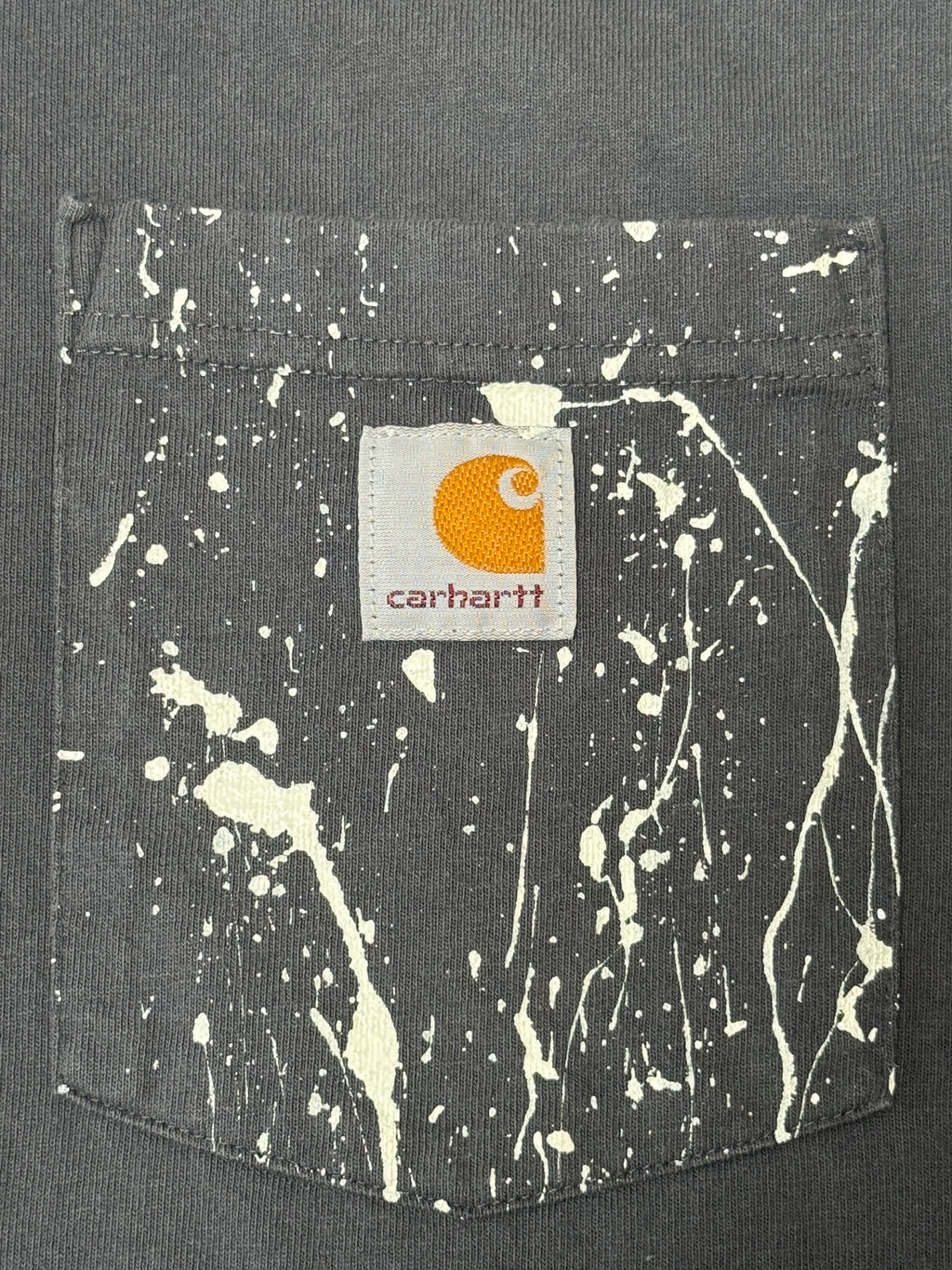 Carhartt pocket logo detail with hand-painted splatter