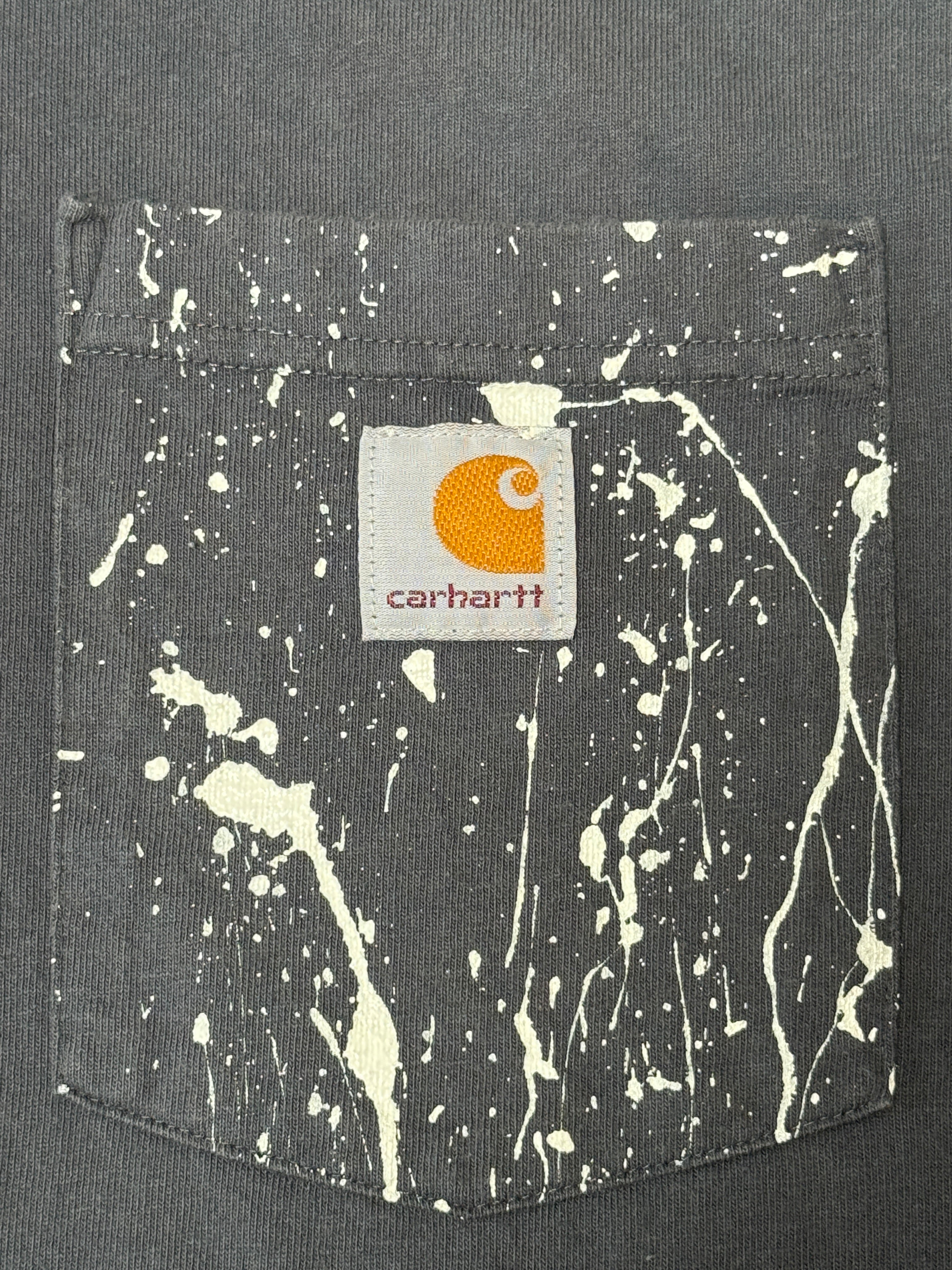 Carhartt pocket logo detail with hand-painted splatter
